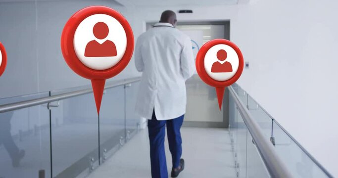 Animation of media icons over african american male doctor walking in hospital