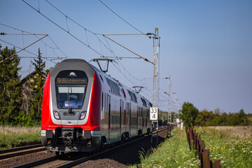 A regional train on a railroad line in the sunshine