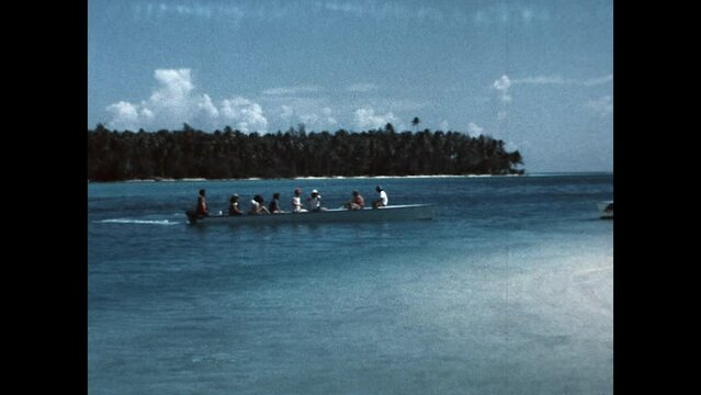 Outrigger Departs 1971 - An outrigger boat carries tourists away from a remote beach near Tahiti, in French Polynesia, in 1971. 