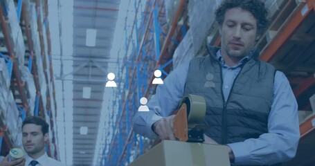 Animation of media icons over caucasian male workers working in warehouse - Powered by Adobe