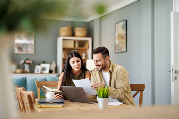  Couple at home office with laptop