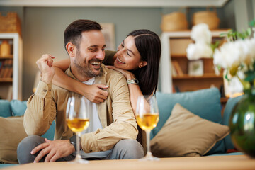 Romantic home celebration-Couple toasting anniversary with wine