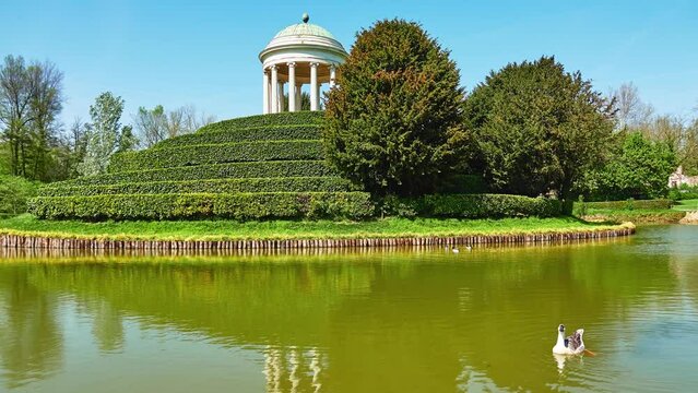 Parco Querini is green area of city of Vicenza, Italy. Monopteros is circular colonnade supporting roof but without any walls. Unlike tholos, it does not have walls making cella or room inside.