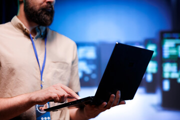 Technical support worker ensuring data center servers are properly equipped to provide redundancy,...