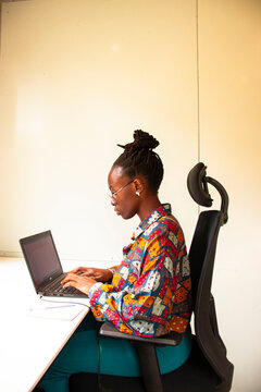 Black lady working on Laptop
