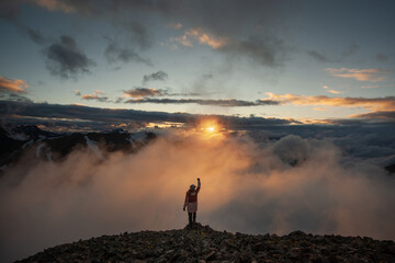Man on the background of mountains with beautiful sky and clouds