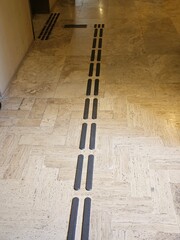 Path for blind or low vision with a textured podotactile surface, so that pedestrians can recognize an obstacle, exit or stairs using their feet or cane