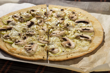 Vegetable pizza, with mushrooms, zucchini and cheese, spiced with oregano.