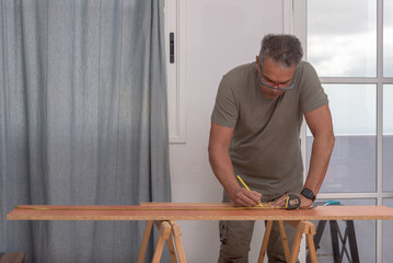 carpenter at home using a pencil