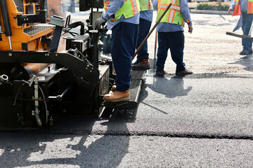 road working crew operate heavy machinery