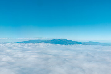 Aerial photography of Honolulu to Hilo from the plane.  From left to right: Mauna Kea, Mauna Loa, and Hualalai. Hawaii island
