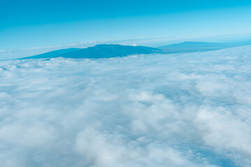 Aerial photography of Honolulu to Hilo from the plane.  From left to right: Mauna Kea, Mauna Loa, and Hualalai. Hawaii island
