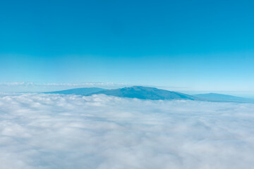 Aerial photography of Honolulu to Hilo from the plane.  From left to right: Mauna Kea, Mauna Loa, and Hualalai. Hawaii island
