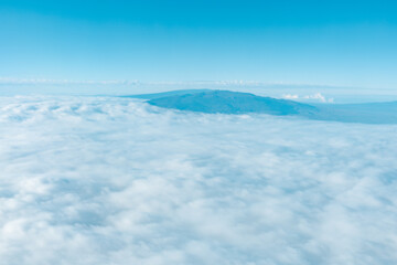 Aerial photography of Honolulu to Hilo from the plane.  From left to right: Mauna Kea, Mauna Loa, and Hualalai. Hawaii island
