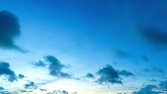aerial hyperlapse view dark cloud moving in blue sky at blue sunset. .Fluffy white clouds curled into various shapes floating in the blue sky. .clouds that move gracefully across the horizon.
