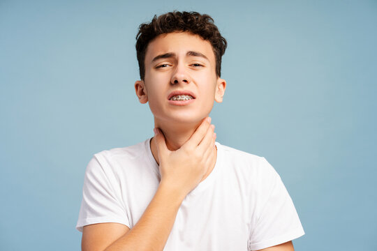 Sick curly boy has a sore throat, strong pain, need medical treatment isolated