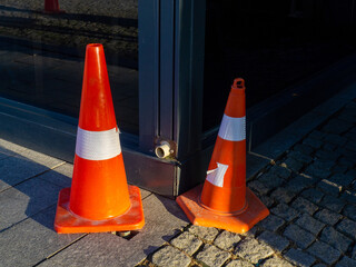 Traffic cones on paving stones. Traffic regulation. Parking.