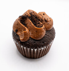 Chocolate cupcake with chocolate frost on top on a white background 