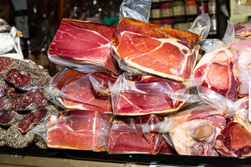 Vacuum packed processed meat products, hamon iberico, prosciutto, salami, sausage, bacon, at food market, Palma, Majorca, Spain.