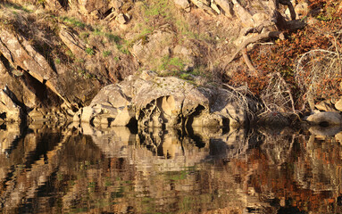 Rocks reflected in surface of tranquil waters