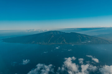 The West Maui Mountains, West Maui Volcano, or Mauna Kahālāwai which means "holding house of water, is approximately 1.7 million years old and forms a much eroded shield volcano.