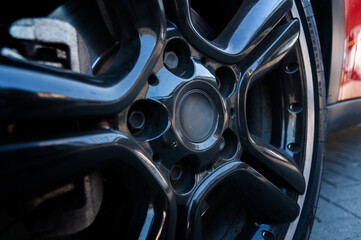 The car's wheel or rim is made of aluminum alloy