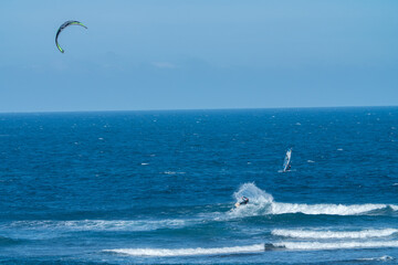 Kite and wind surfer along the coast.