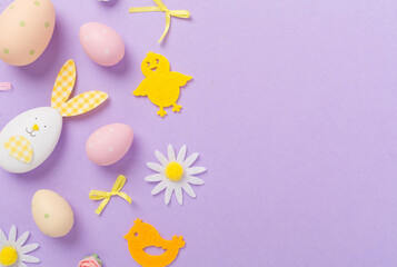 Easter eggs and decoration on color background, top view