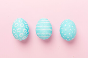 Blue easter eggs on color background, top view