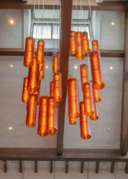 Hanging glass orange light fixtures on vaulted ceiling