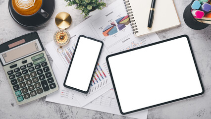 Fototapeta premium A contemporary work desk setup featuring a smartphone, tablet, financial calculator, and coffee, symbolizing organized business planning.