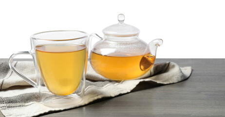 Refreshing green tea in cup and teapot on grey wooden table against white background