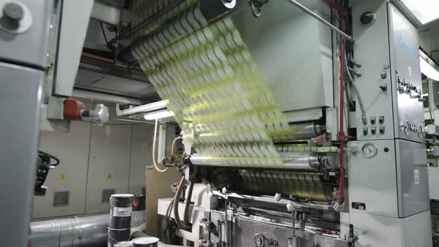 The Inside Scoop on Label Roll Production Process. Labels passing through rollers.