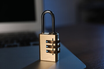 Cyber security. Laptop with padlock on table, closeup