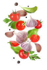 Fresh garlic, peppercorns, tomato and herbs falling on white background