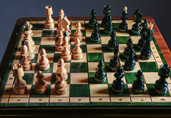 Chess board on the round white table. View with chess pieces on a chess table in contes