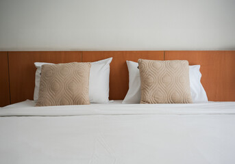  hotel bedroom with a pillows on bedding.