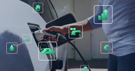 Animation of eco icons and data processing over caucasian man charging electric car - Powered by Adobe