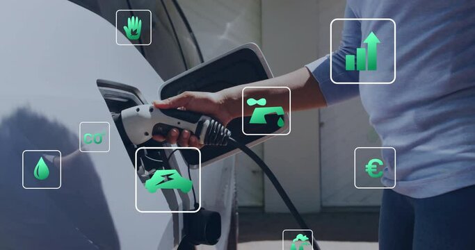 Animation of eco icons and data processing over caucasian man charging electric car