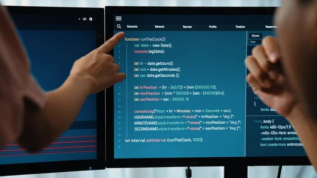 Slow motion back end software developer engineer for computer programming working together on debugging writing computing code, solving complex algorithms display on monitor in office. Burgeoning
