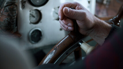 The ship's captain turns the wheel of the ship. Clip. Close up of man hand turning wooden steering...