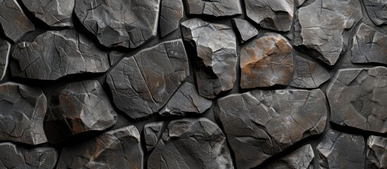A close-up view of a rock wall displaying a patterned stone background with a dark and grey metallic appearance. A rusted metal object is prominently featured on the rock wall.