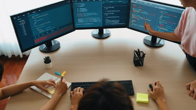 Slow motion back end software developer engineer for computer programming working together on debugging writing computing code, solving complex algorithms display on monitor in office. Burgeoning