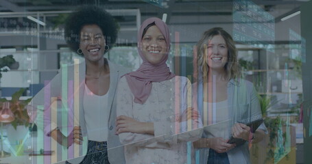 Image of financial data processing over diverse businesswomen in office