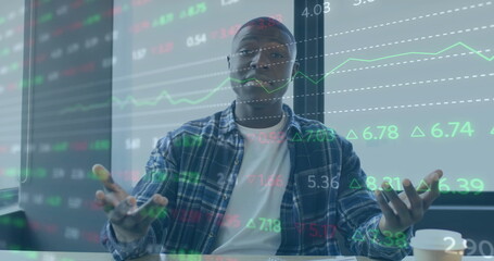 Image of financial data processing over african american businessman working in office