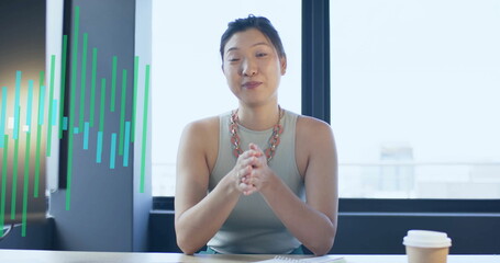 Image of financial data processing over asian businesswoman working in office