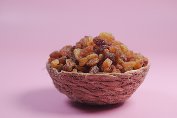 raisin on a bowl on color background