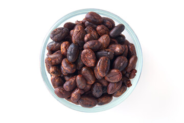Roasted cocoa beans in a glass bowl
