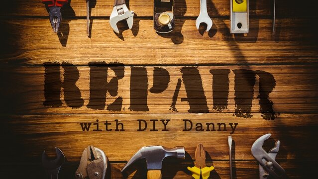 Repair with diy danny text with two rows of tools on wooden floorboards background