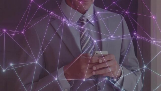 Animation of network of connections over caucasian businessman using smartphone